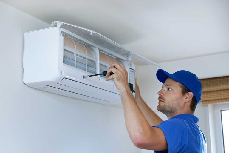 A family adjusting a wall-mounted digital thermostat in a modern living room with visible HVAC vent.